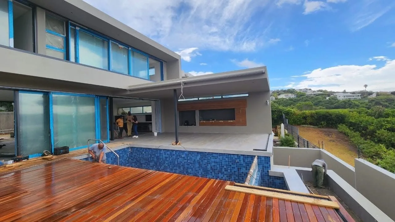 Modern home with mosaic-tiled pool and freshly oiled hardwood deck