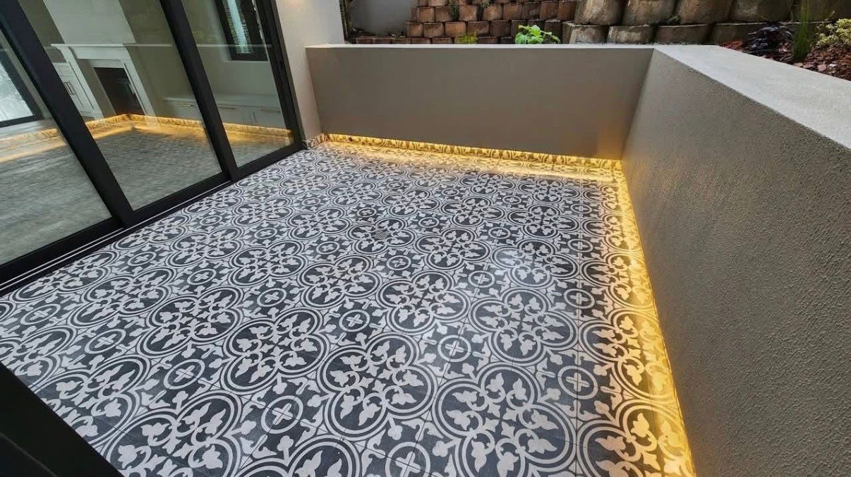 Patterned cement-tile patio with warm LED accent lighting
